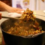 Mixing up jambalaya in a dutch oven