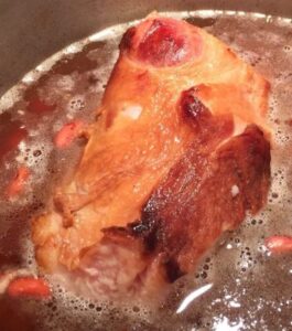 A ham bone in a pot of red beans.