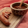 Cranberry BBQ Sauce in Bowl with Ladle and Andouille Sausage