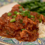Shrimp Creole-21 Shrimp Creole on a plate with green onions and green beans