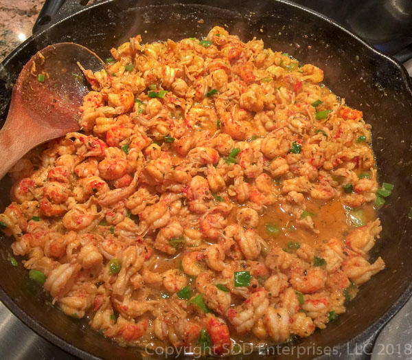 Crawfish tails and green onions in butter