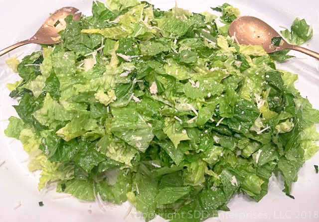 Sensation Salad on a white platter with salad tongs