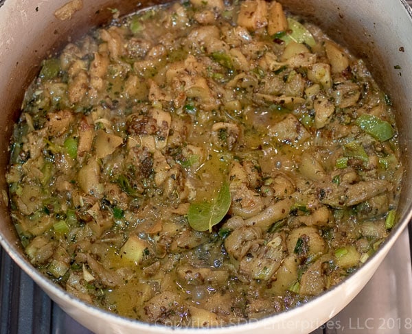 Cooking eggplant, spices and vegetables in dutch oven