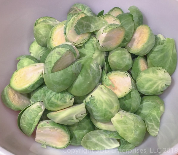 Brussels Sprouts cut in half in a bowl