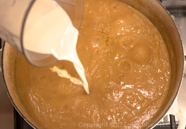 Adding heavy cream to Mirliton Crab Bisque