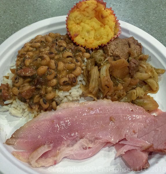 Black-eyed Peas with Smothered Cabbage and Baked Ham on a paper plate