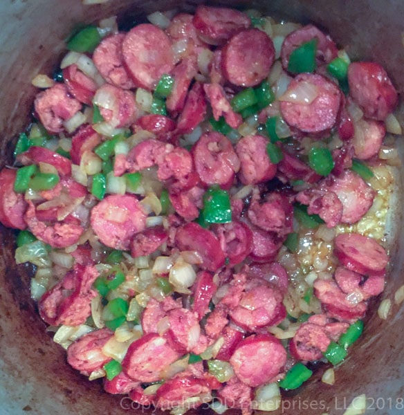 sausage and vegetables in a stock pot for black-eyed peas