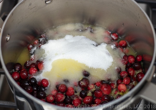 cranberries, sugar and orange juice in a sauce pan
