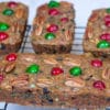 four fruit cakes on a cooling rack