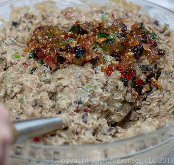 Mixing fruit into the fruit cake batter