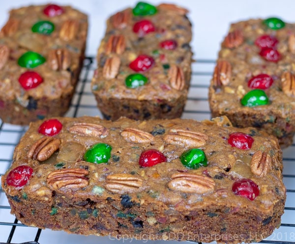 Four fruit cakes on a cooling rack