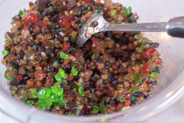 Mixing fruit for fruit cake