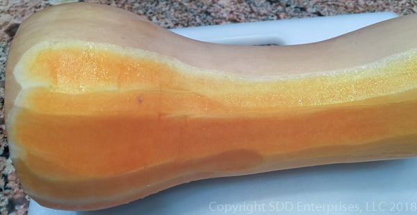 partially peeled butternut squash