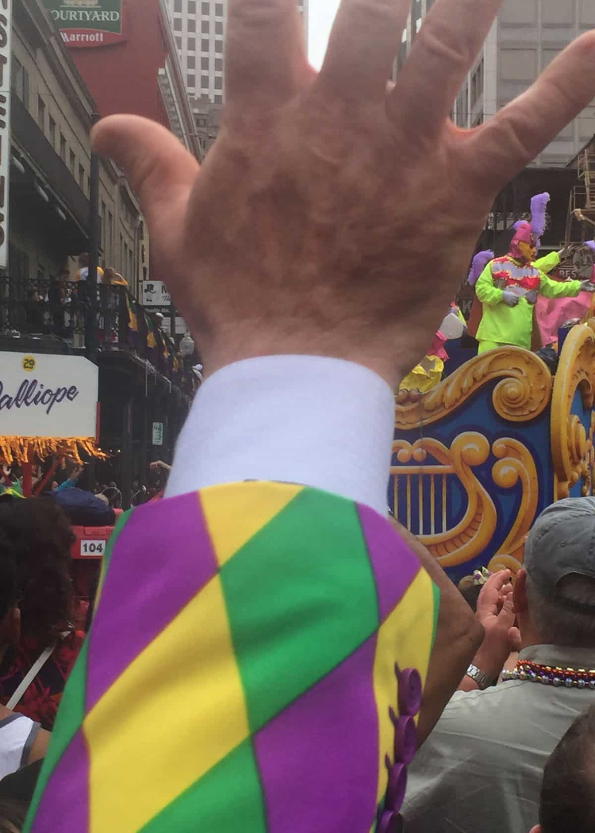 Waving at the floats on Mardi Gras Day