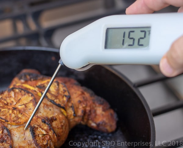 using a Thermopen Classic to check the internal temperature of the pork tenderloin