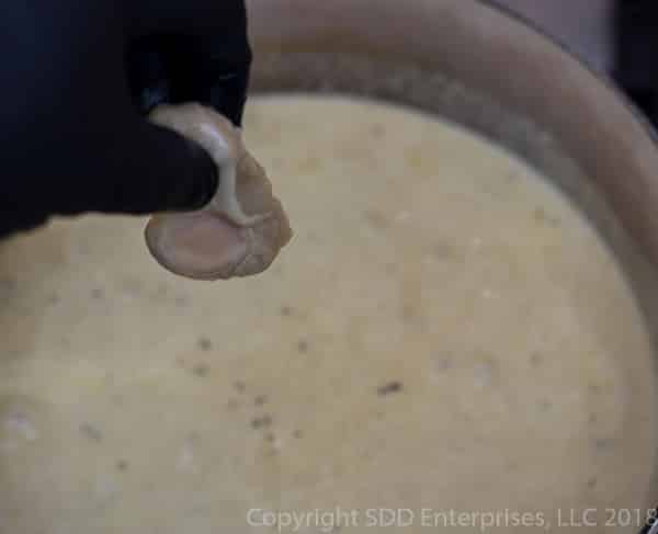 adding an oyster to the stock pot