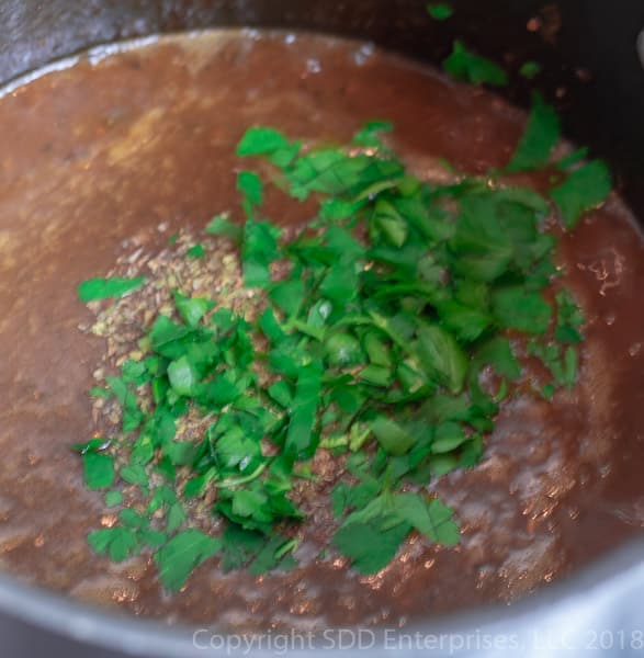 parsle and spices added to the Shrimp and Okra Gumbo