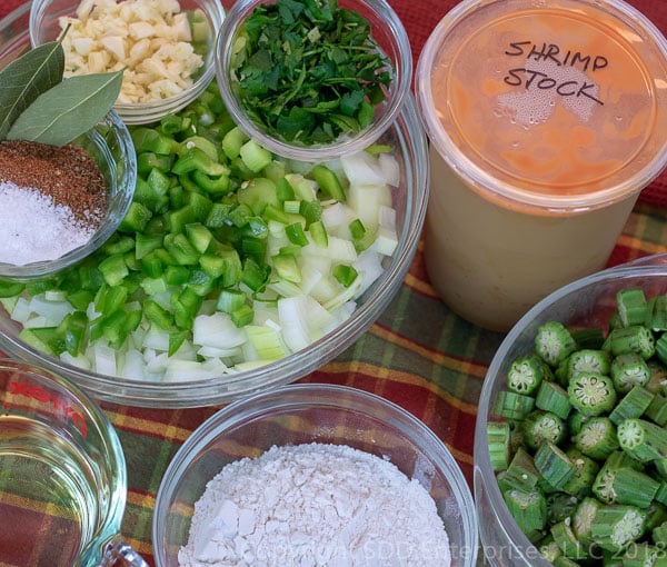 chopped vegetables, stock, oil and flour for shrimp and okra gumbo