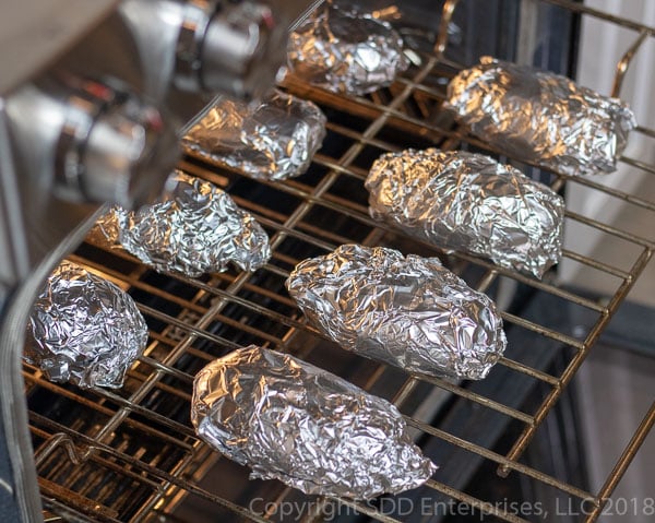 russet potatoes wrapped in foil in the oven