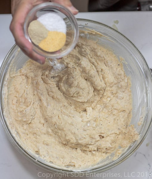 adding spices to the potatoes