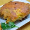 cajun twice baked potato with parsley garnish on a white dish