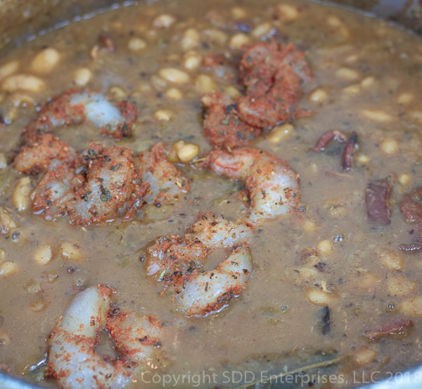 shrimp added to the simmering white beans