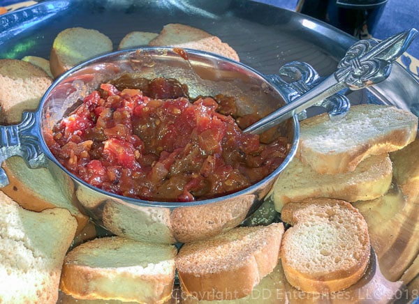 tomato bacon jam in a silver bowl on platter with bread