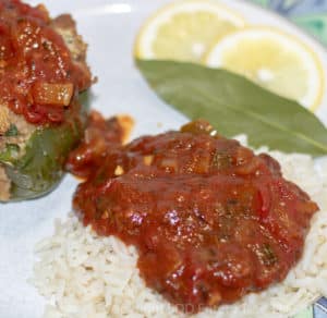 creole sauce served over rice with stuffed pepper and garnished with lemon and bay leaf