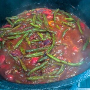 creole green beans smothering in cast iron dutch oven