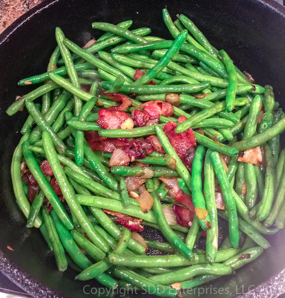 green beans added to the bacon and onions in dutch oven