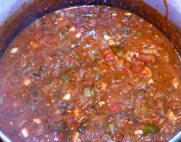 simmering creole sauce in a dutch oven