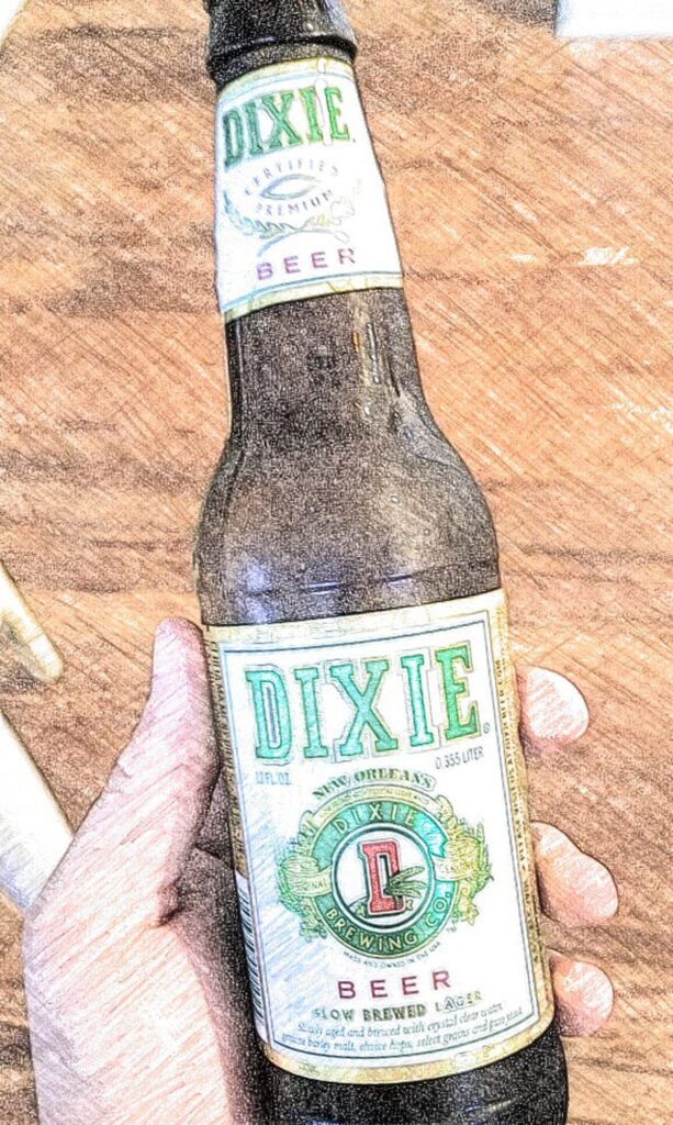 a bottle of Dixie beer held in a hand