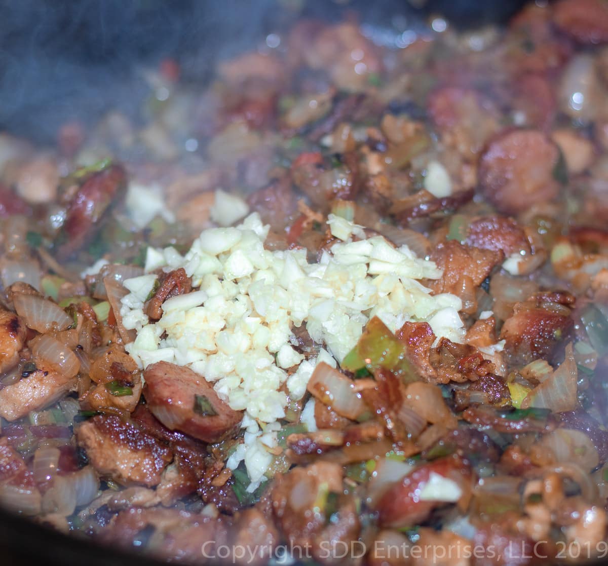 chopped garlic added to vegetables and ,eats for cajun jambalaya