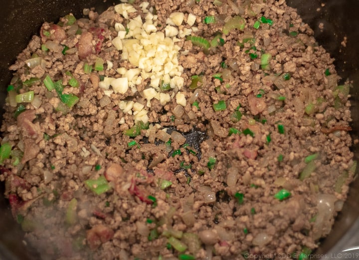 chopped garlic added to the dutch oven with the meats for dirty rice