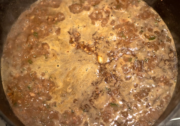 simmering stock for dirty rice in a dutch oven