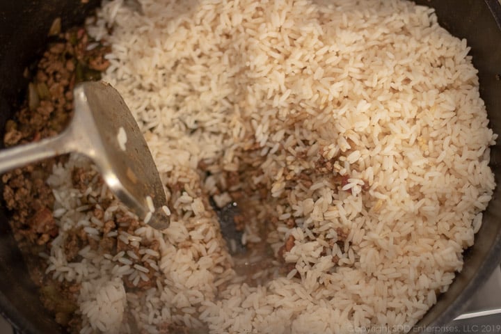 cooked rice added to meats in dutch oven for dirty rice