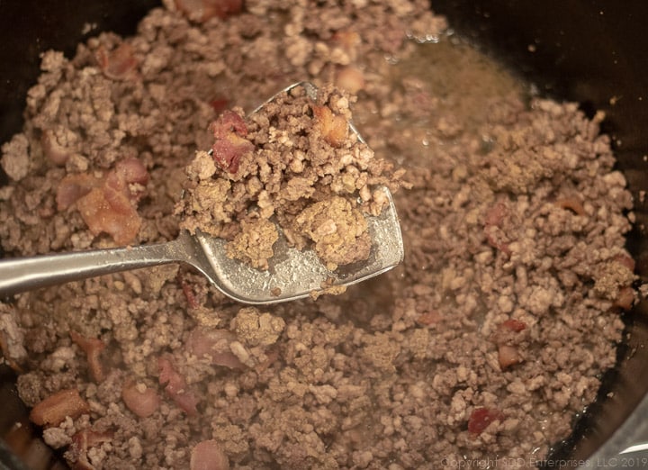 ground beef and pork with chicken liver frying in a dutch oven