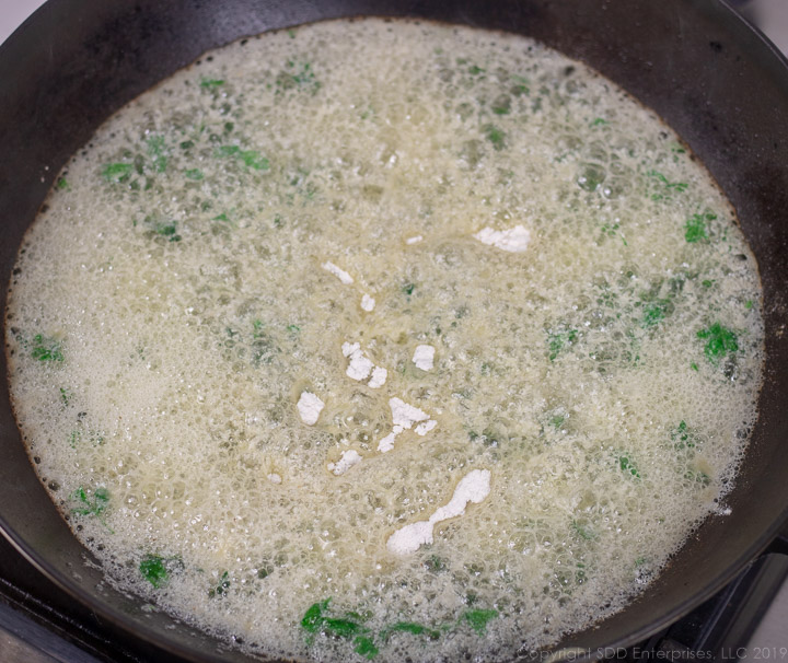 flour added to butter and parsley for meuniere sauce