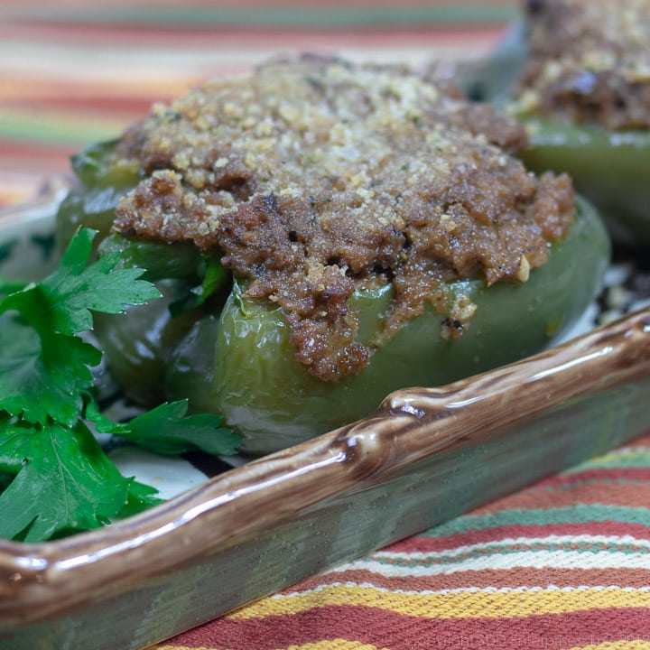 stuffed bell peppers on a platter with parsley garnish
