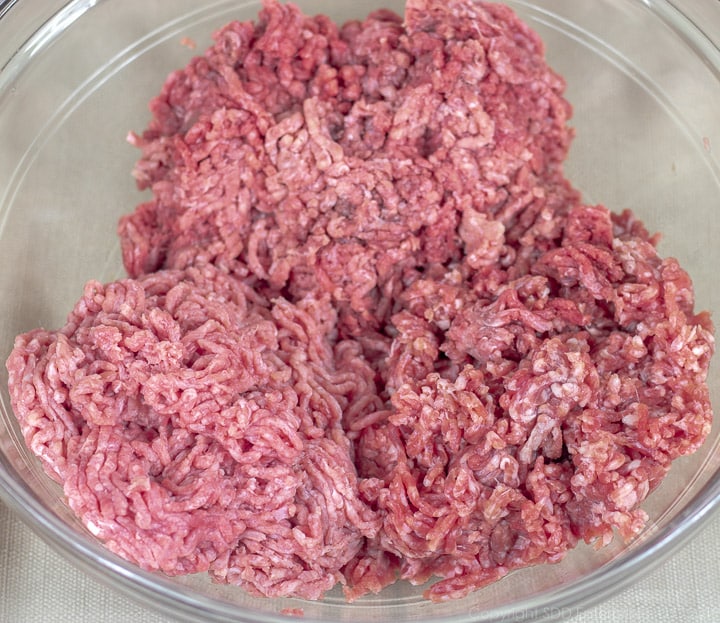 ground beef, veal and pork in a clear bowl