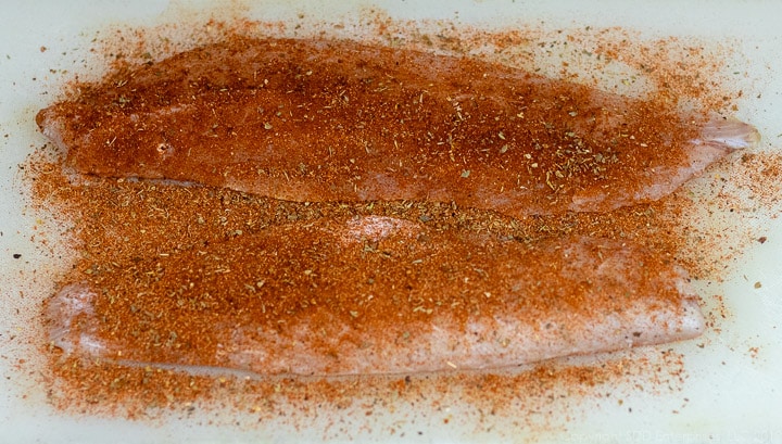 filets of trout with Creole seasonings on a cutting board for trout meuniere