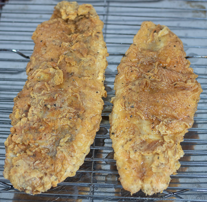 two fried fish filets on as cooling rach