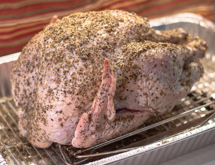 uncooked turkey after dry brining in a pan