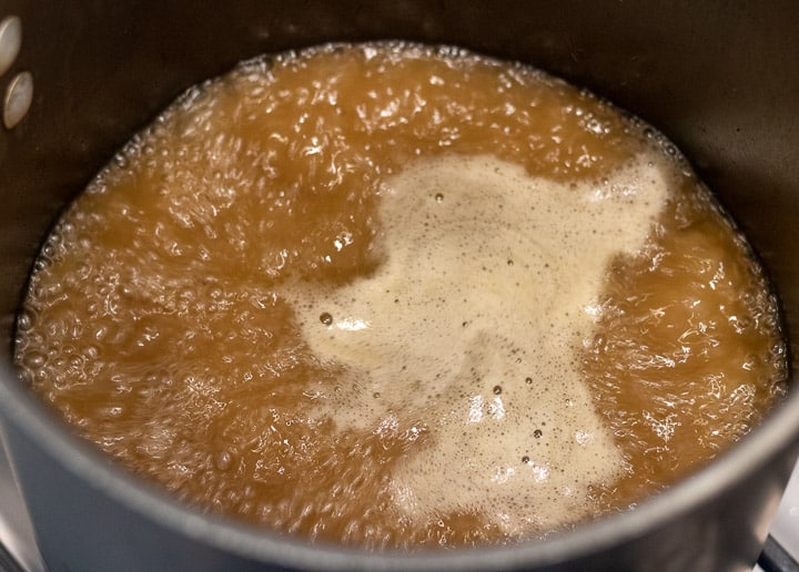 turkey stock boiling in a stockpot for turkey oyster gumbo