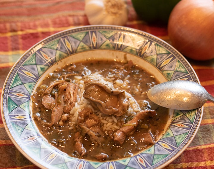 turkey oyster gumbo with rice with a spoon in a bowl