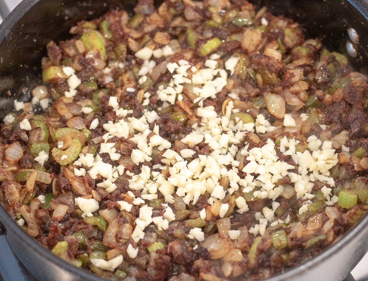 chopped garlic added to the trinity in a frying pan for turkey oyster gumbo