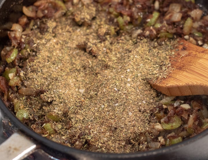 herbs and spices added to trinity in a frying pan for turkey oyster gumbo