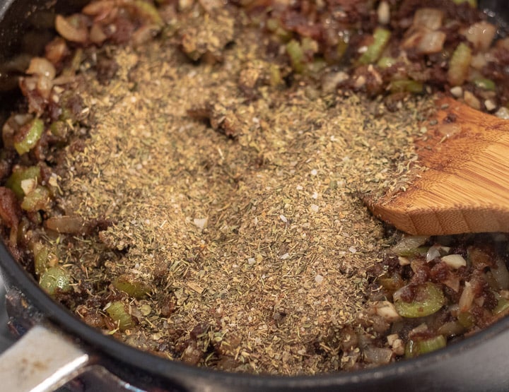 herbs and spices added to trinity in a frying pan for turkey oyster gumbo