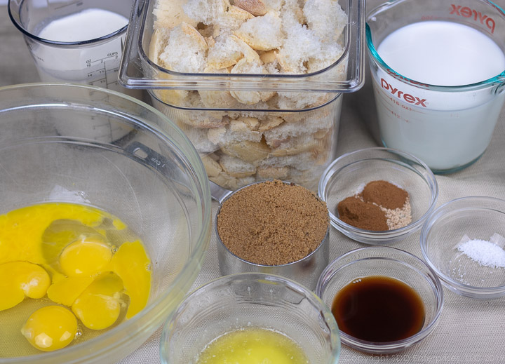 pieces of french bread, milk, cream, eggs, butter and spices for bread pudding