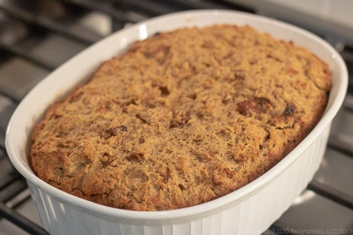 bread pudding right from the oven in a white baking dish